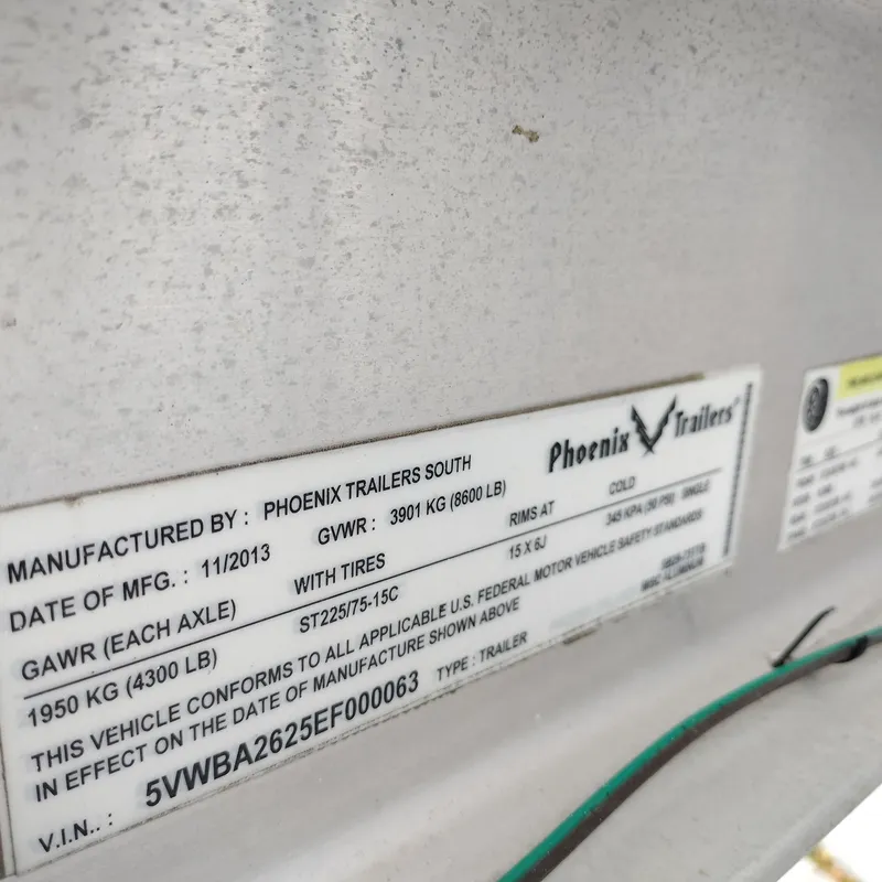 Slide: The Image of Label on Phoenix Trailers South, manufactured 11/2013, showing specifications and VIN details. - 28