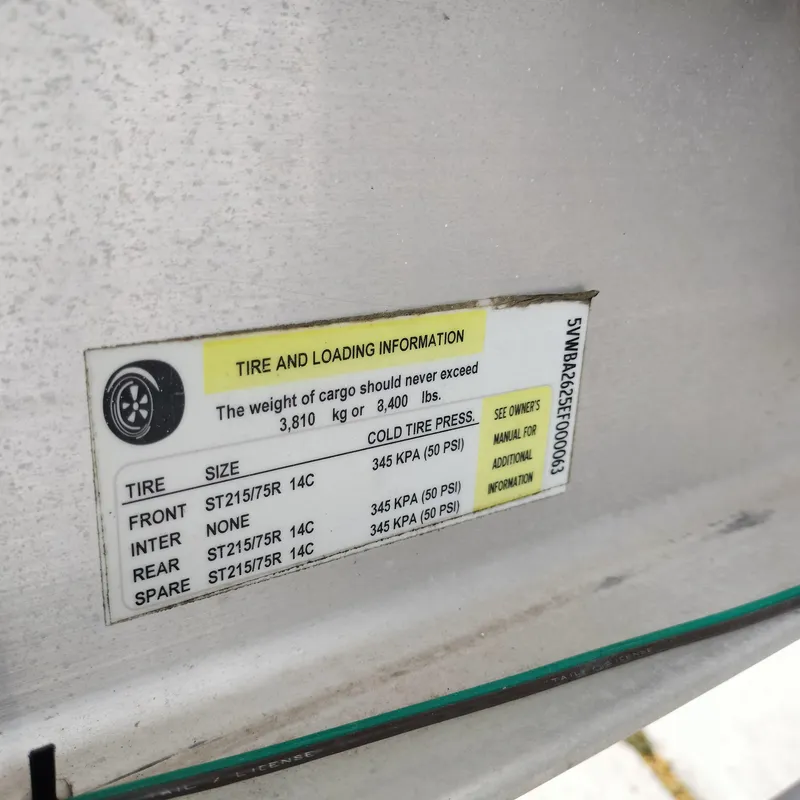Slide: The Image of Tire and loading information label on a 2001 Chris-Craft 26 Constellation boat. - 29
