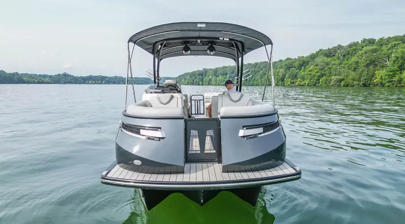 Slide: The Image of 2022 Montara MT 2.0 25 CW boat on a serene lake with lush green shoreline. - 10