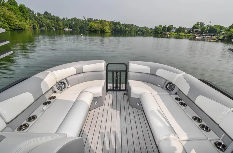 Slide: The Image of 2022 Montara MT 2.0 25 CW boat interior with spacious seating on a serene lake. - 13