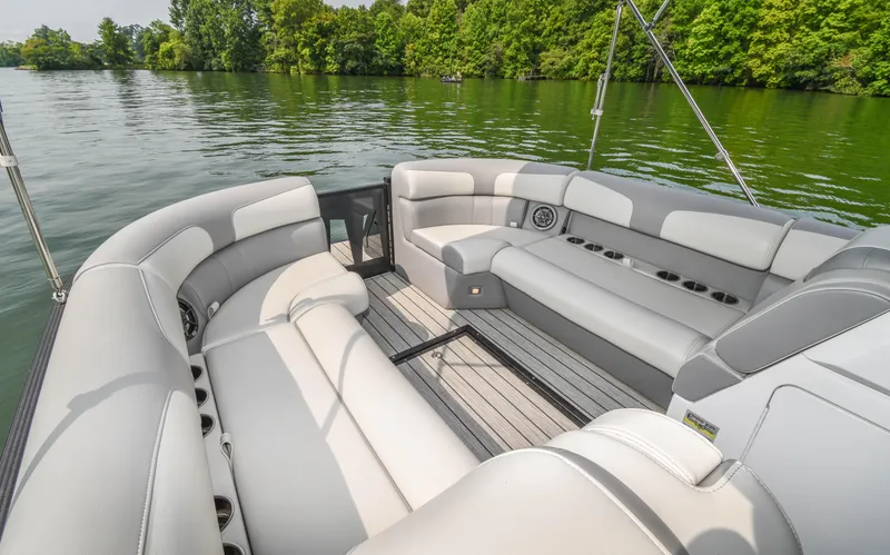 Slide: The Image of 2022 Montara MT 2.0 25 CW boat interior with plush seating on a serene lake. - 14