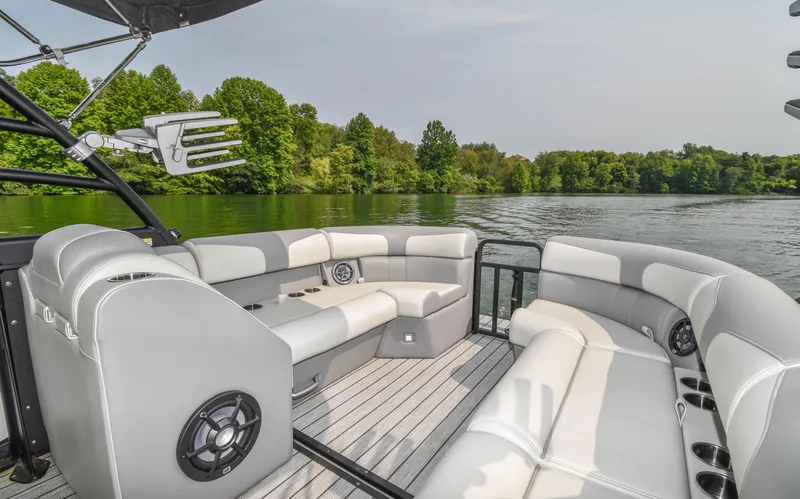 Slide: The Image of 2022 Montara MT 2.0 25 CW boat interior with plush seating on a serene lake. - 15