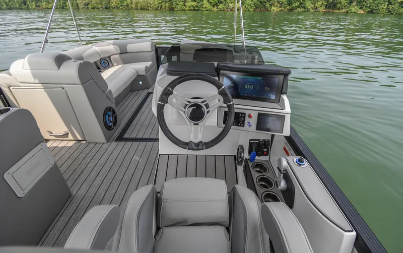 Slide: The Image of 2022 Montara MT 2.0 25 CW boat interior with modern steering and seating on a lake. - 19