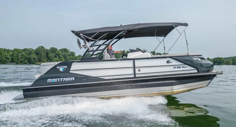 Slide: The Image of 2022 Montara MT 2.0 25 CW boat cruising on a lake with canopy. - 2
