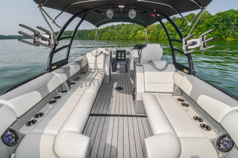 Slide: The Image of 2022 Montara MT 2.0 25 CW boat interior with spacious seating on a serene lake. - 21