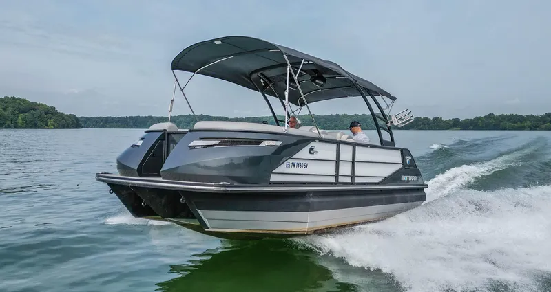 Slide: The Image of 2022 Montara MT 2.0 25 CW boat cruising on a lake with canopy. - 4