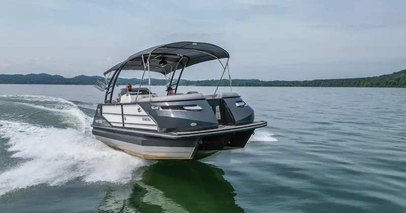 Slide: The Image of 2022 Montara MT 2.0 25 CW boat cruising on a lake with scenic background. - 9