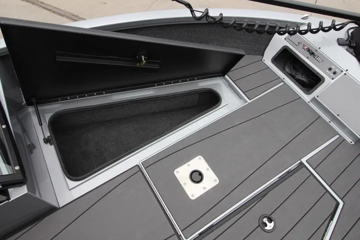 Slide: The Image of 2025 Vexus ADX 200 boat deck with open storage compartment and sleek design. - 14