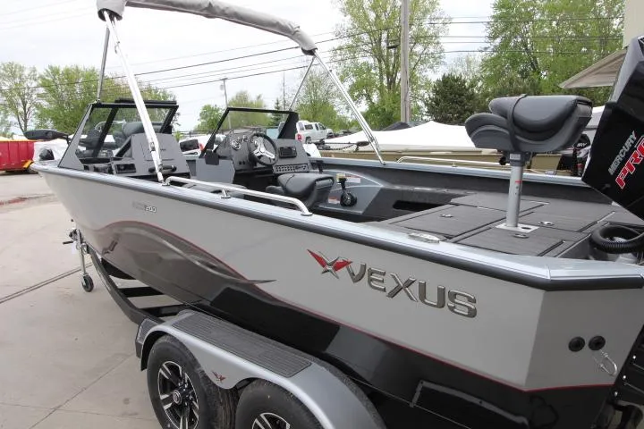 Slide: The Image of 2025 Vexus ADX 200 boat with sleek design and modern features, parked outdoors. - 2