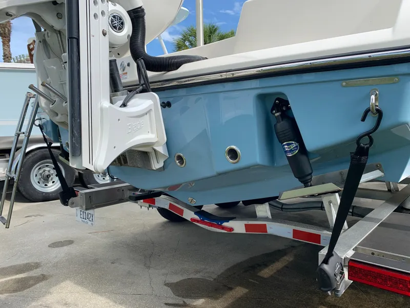 Slide: The Image of 2024 Pathfinder 2400 TRS boat on trailer, showcasing rear hull and motor mount. - 11