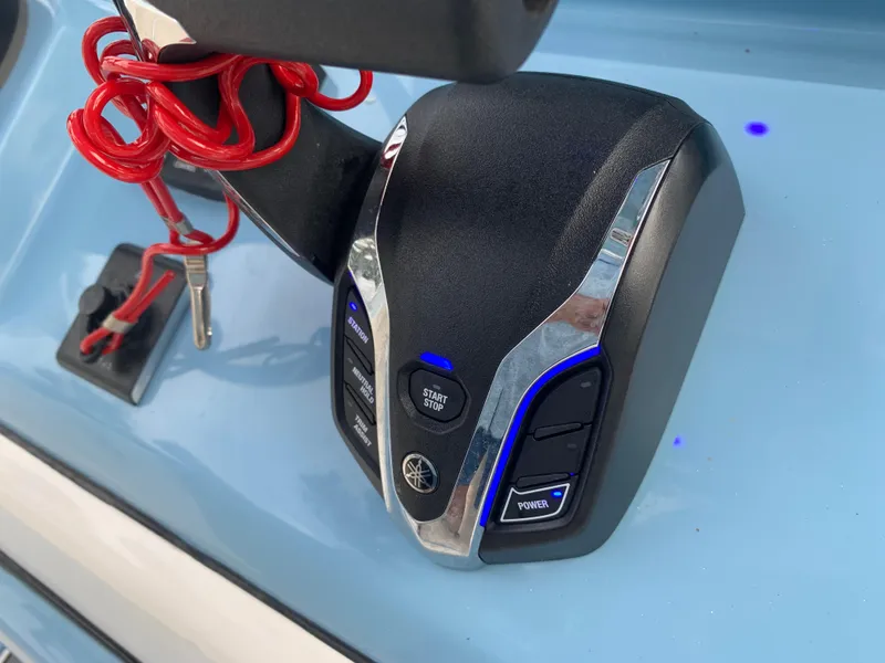 Slide: The Image of 2024 Pathfinder 2400 TRS boat control panel with red safety lanyard and start button. - 25