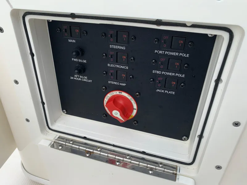 Slide: The Image of Control panel of 2024 Pathfinder 2400 TRS boat with switches and red dial. - 31