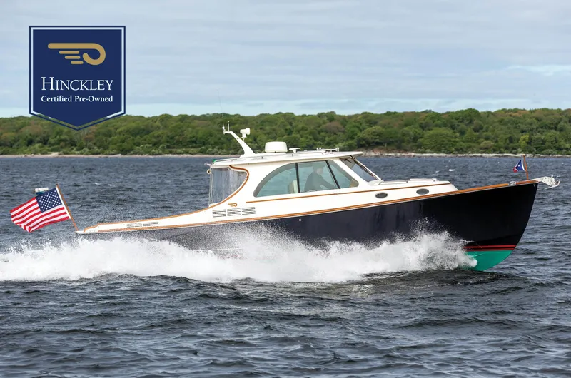 The Image of 2023 Hinckley Picnic Boat 34 S cruising on water with American flag. - 0