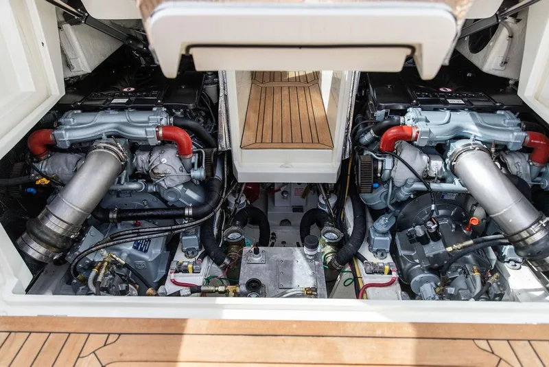 Slide: The Image of Engine compartment of 2023 Hinckley Picnic Boat 34 S, showcasing dual engines and mechanical components. - 20