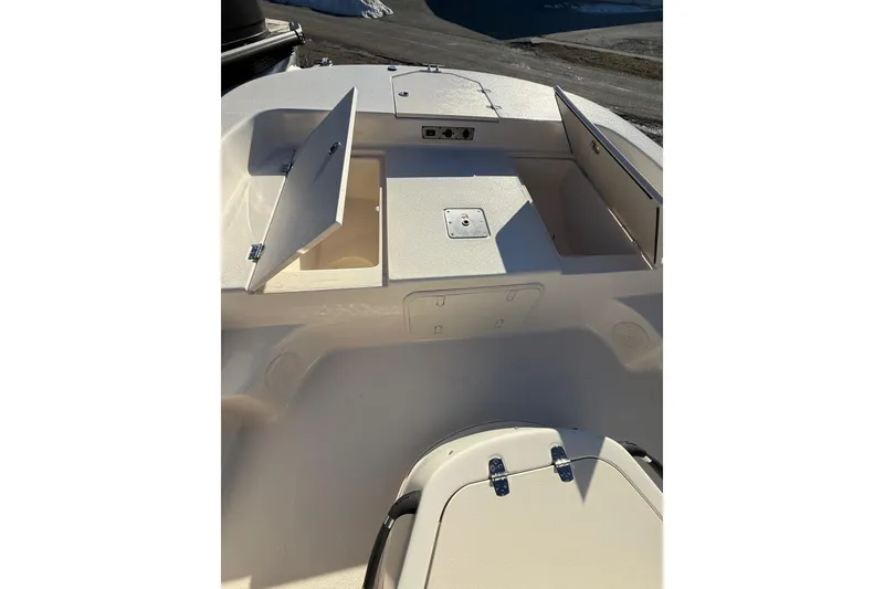Slide: The Image of 2025 Carolina Skiff 19 LS boat deck with open storage compartments. - 13