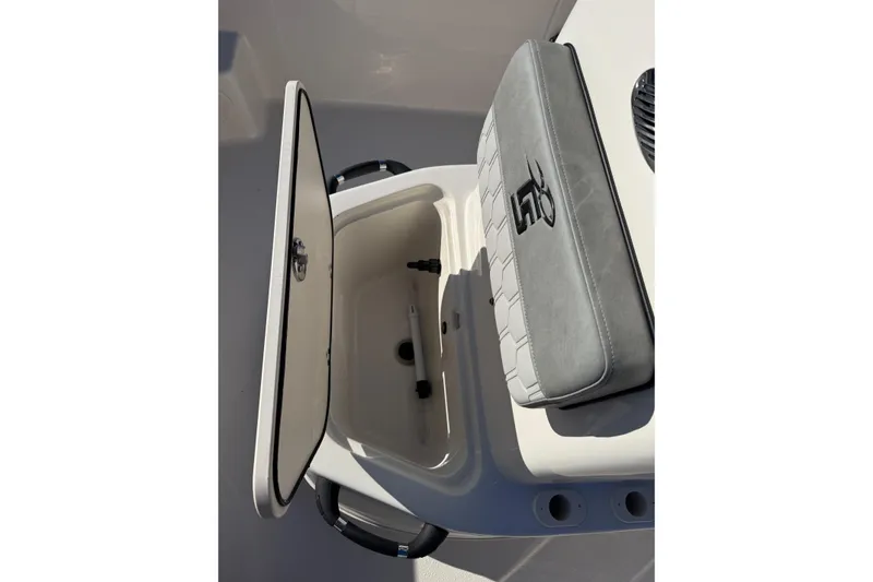Slide: The Image of 2025 Carolina Skiff 19 LS boat storage compartment with cushioned seat. - 14