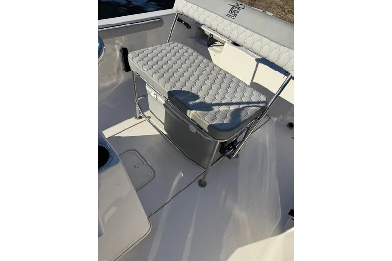 Slide: The Image of 2025 Carolina Skiff 19 LS boat interior with cushioned seating and storage. - 16