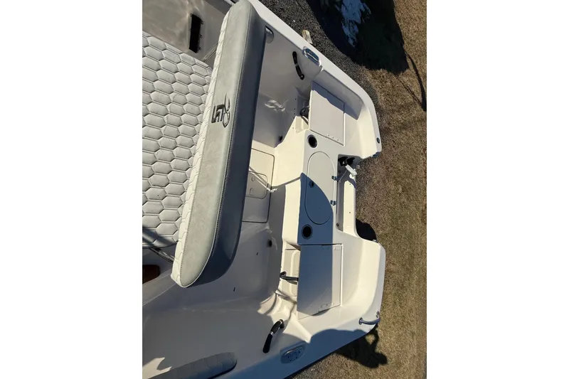 Slide: The Image of 2025 Carolina Skiff 19 LS boat interior with seating and storage compartments. - 17