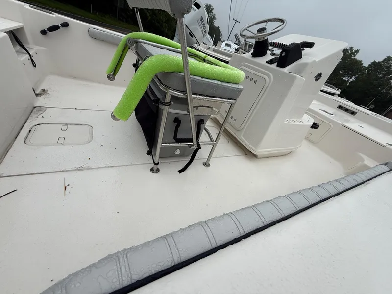 Slide: The Image of 2025 Carolina Skiff 19 LS boat on trailer, side view, light blue and white design. - 3