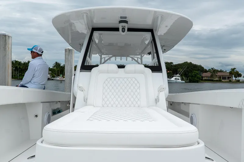 Slide: The Image of 2026 Front Runner 37 Catamaran with luxurious seating, docked by a scenic waterfront. - 11