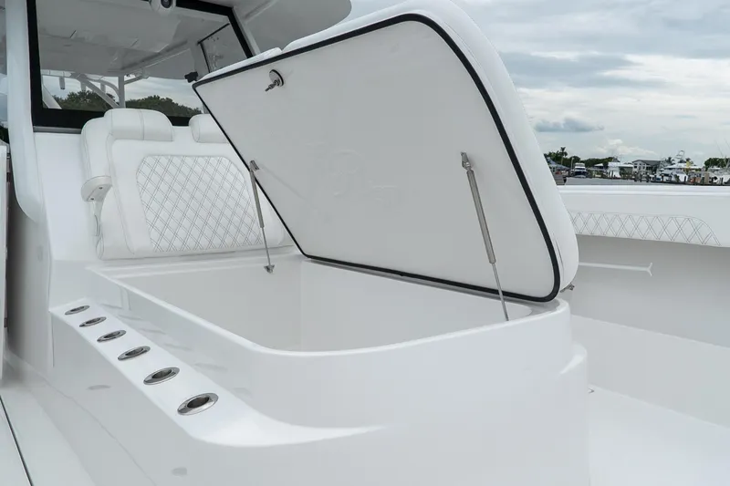 Slide: The Image of 2026 Front Runner 37 Catamaran with open storage compartment and cushioned seating. - 13