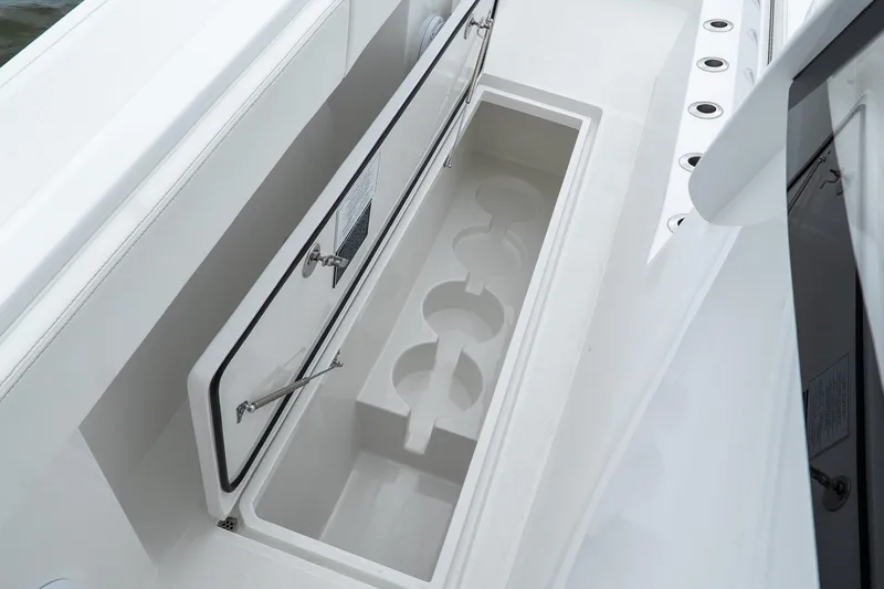 Slide: The Image of Storage compartment on 2026 Front Runner 37 Catamaran, featuring cup holders and sleek design. - 16