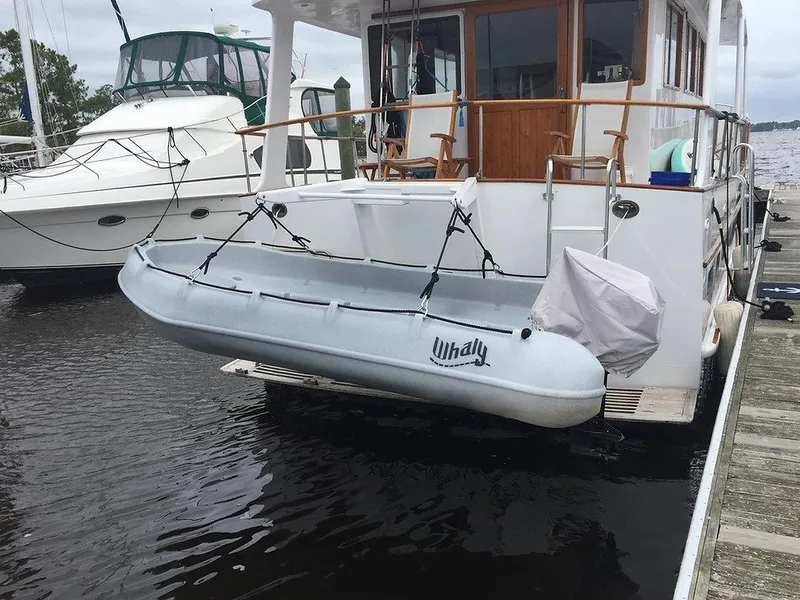 Slide: The Image of Whaly 370 Console 2025 boat docked, secured on a yacht's stern platform. - 4