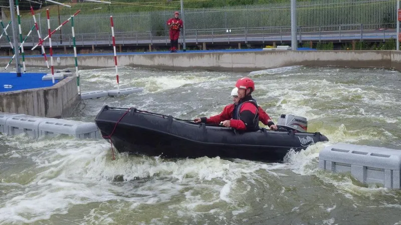 Slide: The Image of Two people navigating rapids in a 2025 Whaly 370 Console boat. - 7
