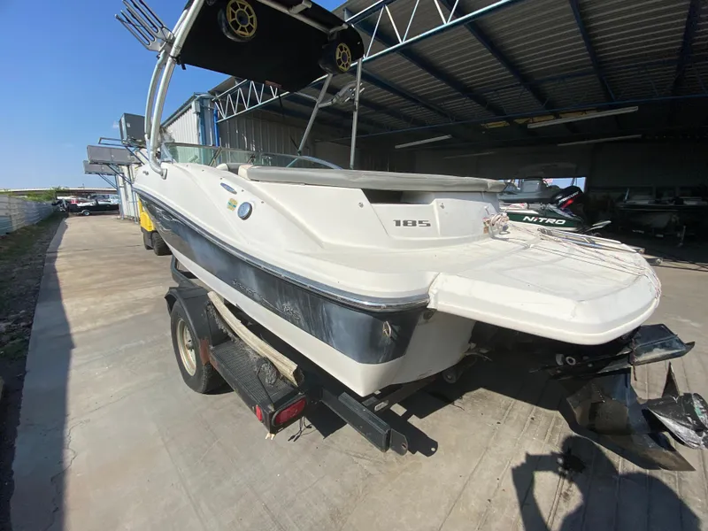 Slide: The Image of 2008 Sea Ray 185 Sport boat on trailer in a covered storage area. - 2