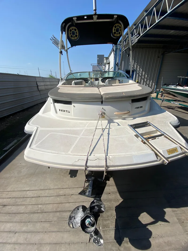 Slide: The Image of 2008 Sea Ray 185 Sport boat with swim platform and ladder, docked in a marina. - 3