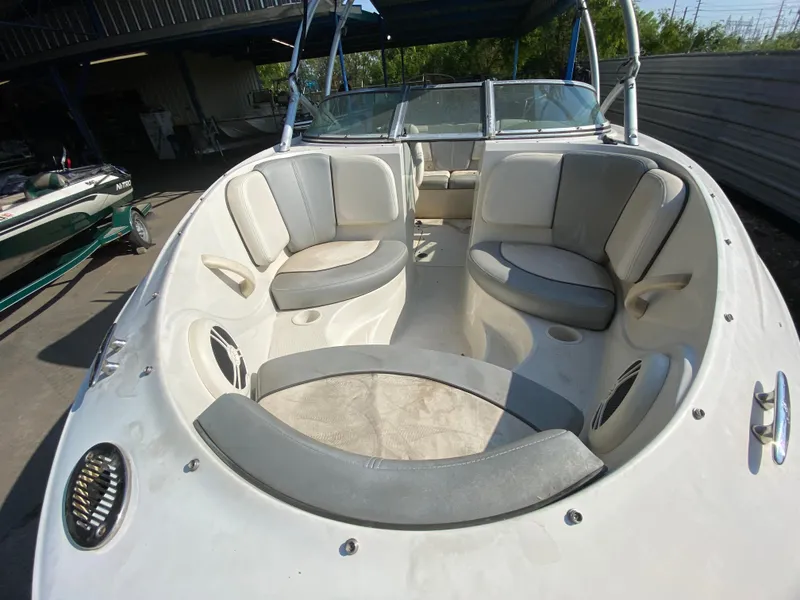 Slide: The Image of 2008 Sea Ray 185 Sport boat interior with cushioned seating and open bow design. - 4