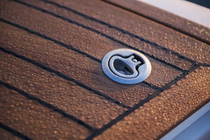 Slide: The Image of Teak deck detail of 2025 Marex 360 Cabriolet Cruiser with metal fitting. - 12