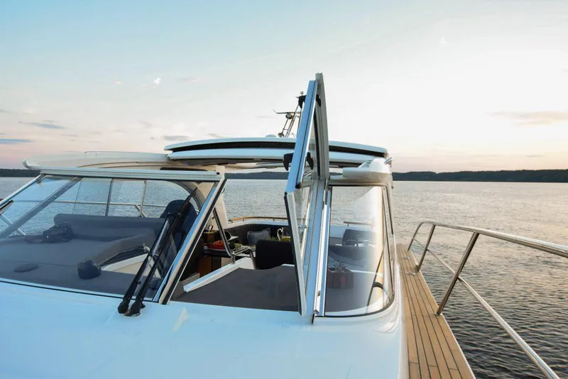 Slide: The Image of 2025 Marex 360 Cabriolet Cruiser on serene water at sunset. - 17