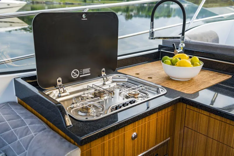 Slide: The Image of Outdoor kitchen on 2025 Marex 360 Cabriolet Cruiser with stove and fruit bowl. - 18