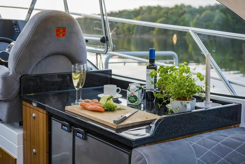 Slide: The Image of Luxurious Marex 360 Cabriolet Cruiser kitchen with wine, herbs, and scenic lake view, 2025 model. - 19