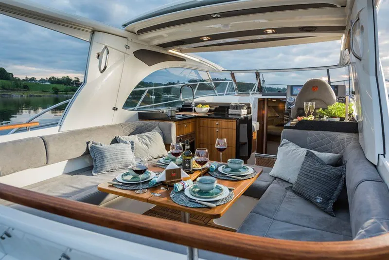 Slide: The Image of Luxurious 2025 Marex 360 Cabriolet Cruiser with elegant dining setup on deck. - 20