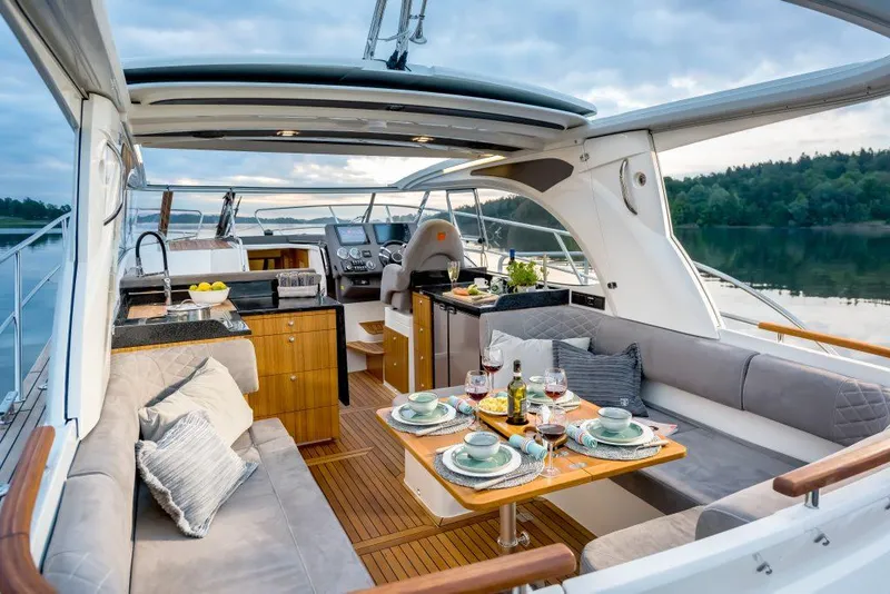 Slide: The Image of Luxurious 2025 Marex 360 Cabriolet Cruiser with elegant dining setup on deck. - 21