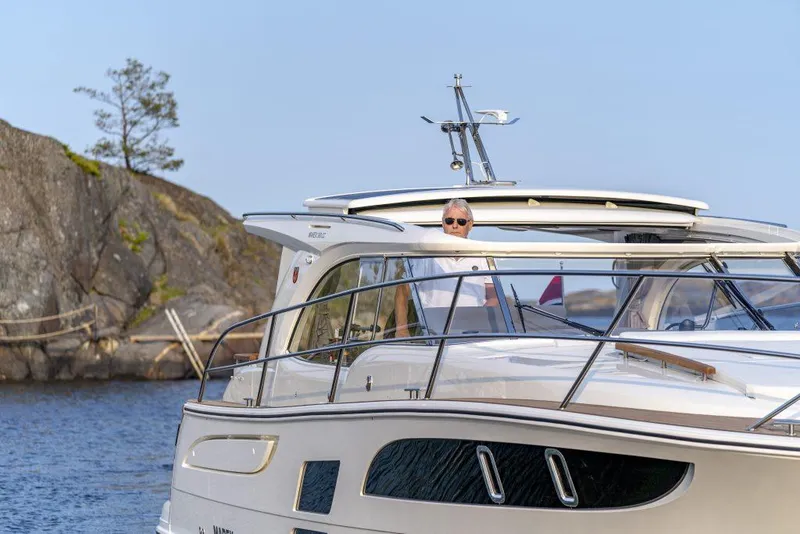 Slide: The Image of 2025 Marex 360 Cabriolet Cruiser on water, scenic rocky background. - 26