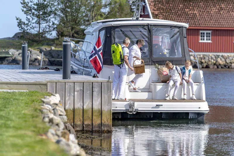Slide: The Image of Family enjoying a day on a 2025 Marex 360 Cabriolet Cruiser by the dock. - 27
