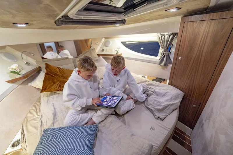 Slide: The Image of Two children in a cozy cabin of a 2025 Marex 360 Cabriolet Cruiser. - 34