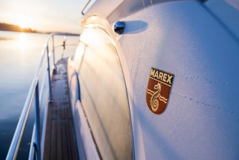 Slide: The Image of 2025 Marex 360 Cabriolet Cruiser yacht at sunrise, showcasing sleek design and logo. - 35