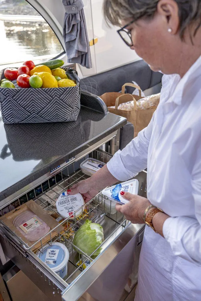 Slide: The Image of Person organizing food in Marex 360 Cabriolet Cruiser kitchen, 2025 model. - 29