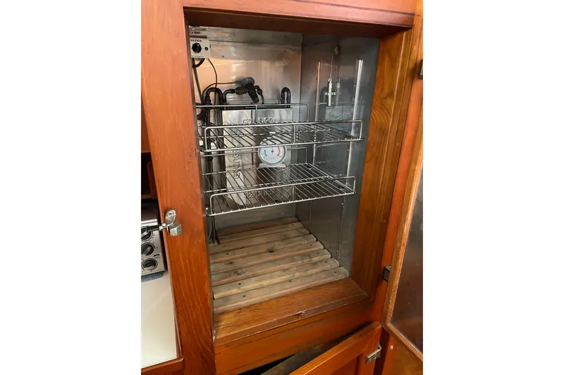 Slide: The Image of Deck of 1991 Grand Banks 46 Motoryacht with wooden flooring and metal railings. - 12