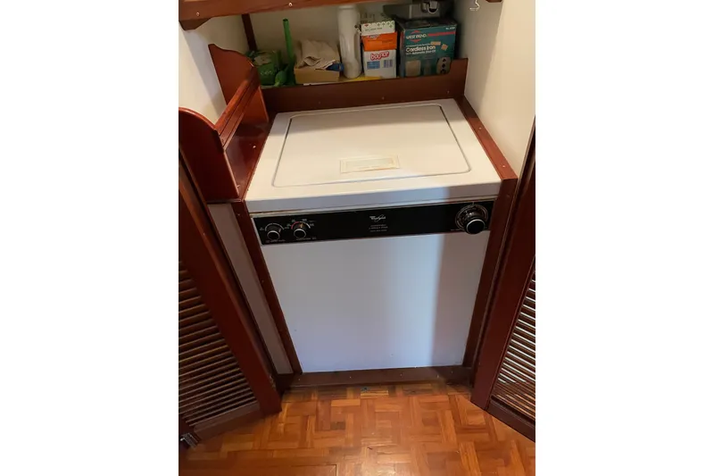 Slide: The Image of Empty wooden cabinet with metal shelves in a 1991 Grand Banks 46 Motoryacht. - 19