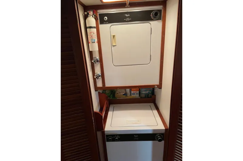 Slide: The Image of Interior of 1991 Grand Banks 46 Motoryacht with wooden drawers and colorful cushions. - 20