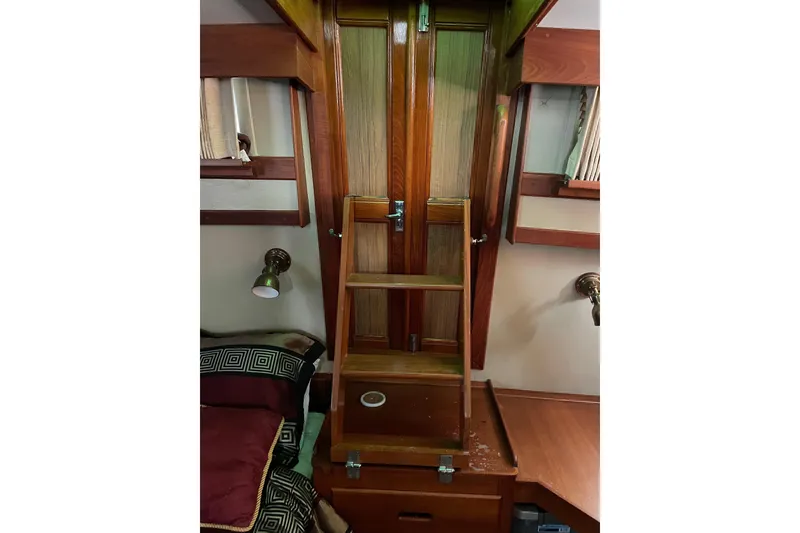 Slide: The Image of Cozy cabin interior of 1991 Grand Banks 46 Motoryacht with stacked cushions and marine decor. - 22