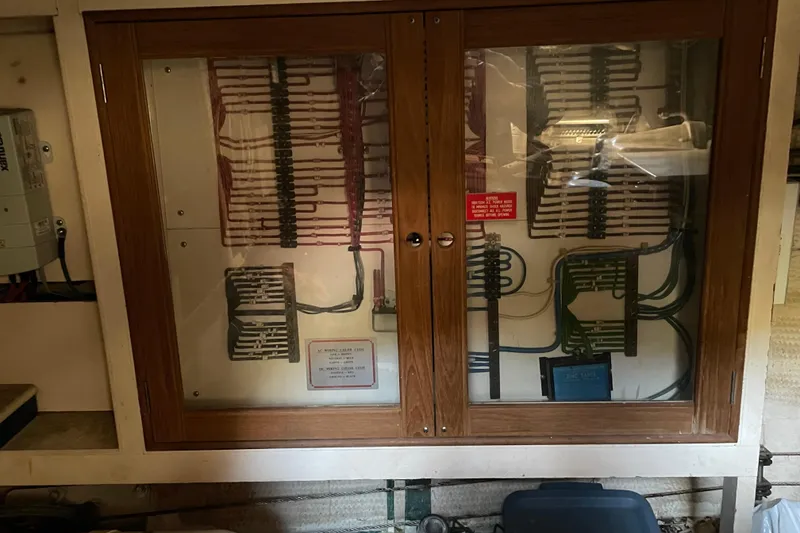 Slide: The Image of Wooden helm of a 1991 Grand Banks 46 Motoryacht with classic nautical instruments. - 38