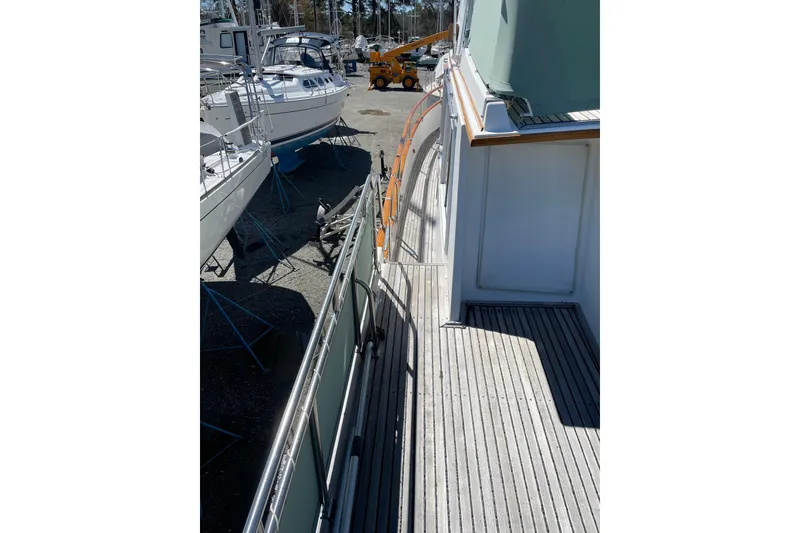 Slide: The Image of Side deck view of a 1991 Grand Banks 46 Motoryacht in a boatyard. - 56
