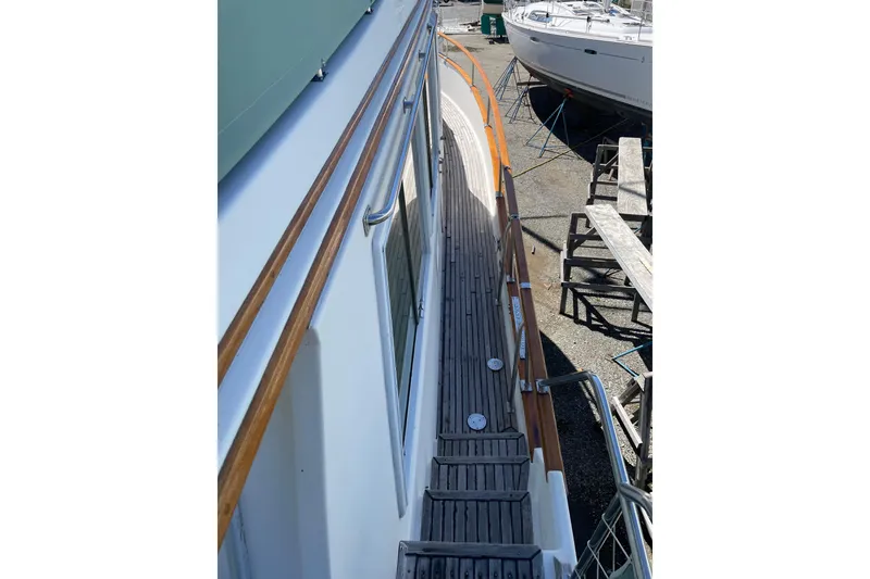 Slide: The Image of Side deck view of 1991 Grand Banks 46 Motoryacht with wooden railings and steps. - 59
