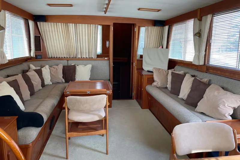 Slide: The Image of Covered seating area on 1991 Grand Banks 46 Motoryacht deck, featuring protective covers and wooden flooring. - 6